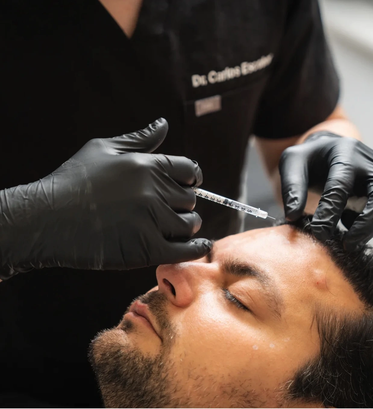 Person receiving an anti-wrinkle injection at The Axis Clinic with text overlay promoting 10% off for new patients.