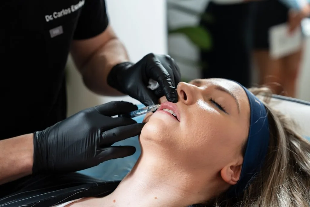 Dr Carlos Escobar performing precise lip filler treatment at The Axis Clinic London