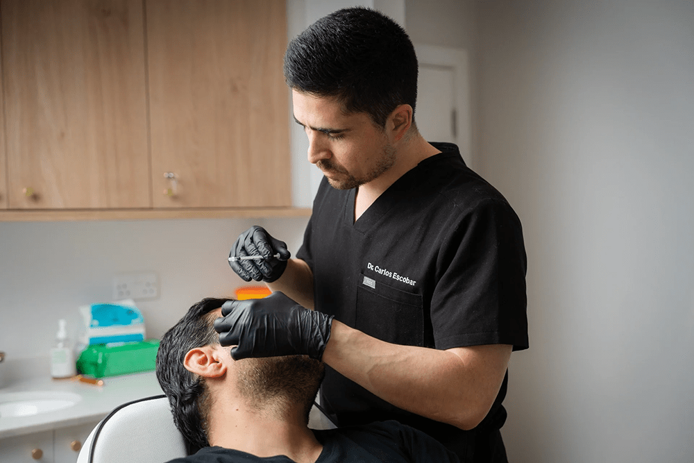 Dr. Carlos Escobar administering Botox under the eyes at The Axis Clinic