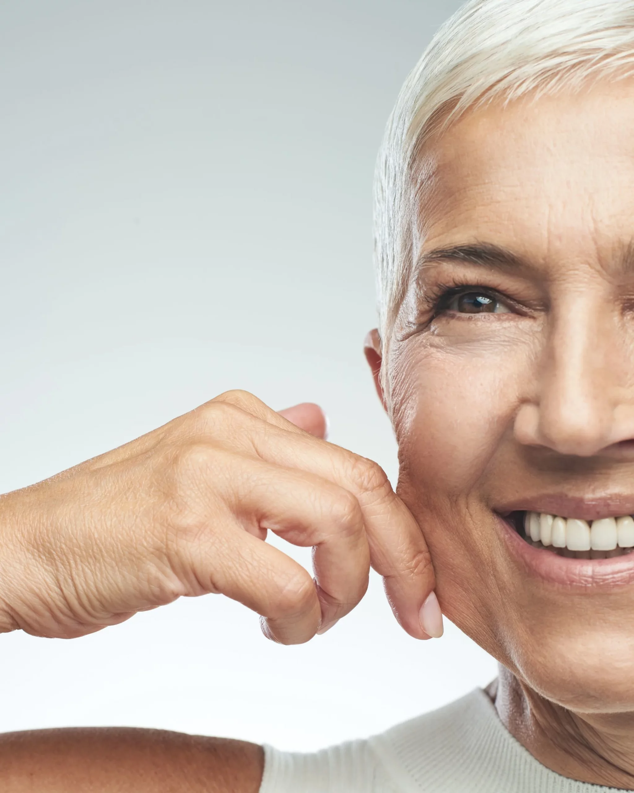 Woman with sagging facial skin and loss of firmness before skin tightening treatment at Axis Clinic London